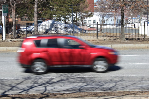 Picture of moving car showing blur to slow shutter speed of 1/60 second