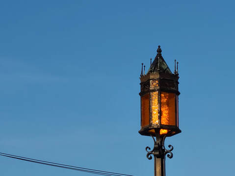 Negative space picture of old lampost against the sky